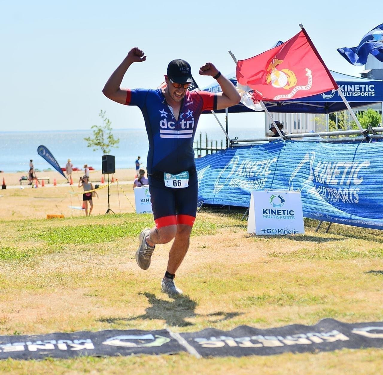 francisco sandi crossing the finish line of the colonial beach olympic triathlon, 2024